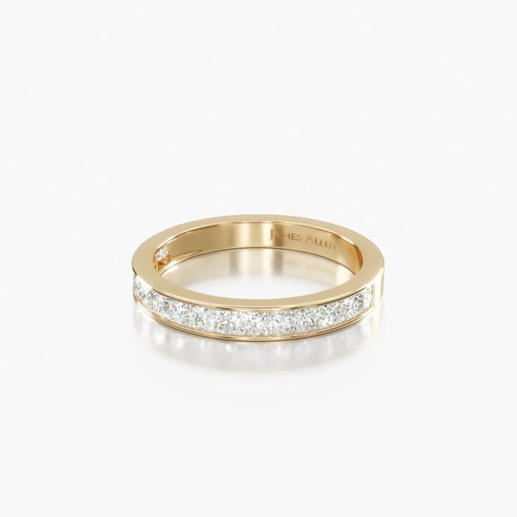 a yellow gold wedding band with channeled diamonds