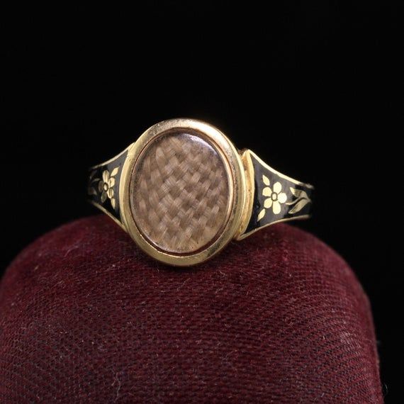 Beautiful Antique Victorian 18K Yellow Gold Enamel Hair Mourning Ring. This amazing ring has pristine enameling and the hair is still intact inside the glass. It has flower designs on the side of the ring without any damage which is rare. The inside of the ring is hallmarked.Item #R0926Metal: 18K Yellow Gold.Weight: 4 GramsRing Size: 8Measurements: Top measures 13 mm wide and band measures 2.8 mm wide.Measurement from finger to top of ring: 3.75  mmLayaway: For your convenience, we will be happy Antique Yellow Gold Enamel Ring, Antique Enamel Wedding Ring, Elegant Formal Enamel Signet Ring, Elegant Yellow Gold Enamel Signet Ring, Victorian Gold Enamel Ceremonial Ring, Victorian Hallmarked Enamel Ring For Wedding, Antique Yellow Gold Enamel Ring For Ceremonial Occasions, Antique Yellow Gold Enamel Ring For Ceremonies, Victorian Hallmarked Oval Enamel Ring