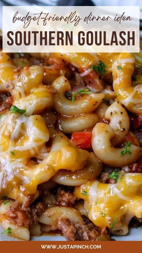 a white plate topped with pasta and meat covered in cheese, sauce and parsley