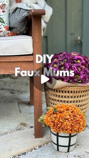 a flower pot sitting on the ground next to a wooden chair with flowers in it