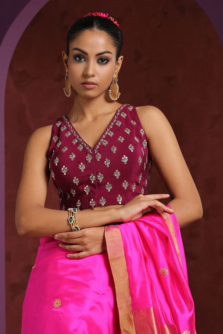 Wine saree blouse with hand embroidered zardozi floral motifs.
Component: 1
Pattern: Embroidery
Type Of Work: Zardozi
Neckline: V neck
Sleeve Type: Sleeveless
Fabric: Crepe
Color: Wine
Other Details: 
Low back with tie up and tassels
Closure: Front hook
Note: Saree worn by the model is not for sale
Occasion: Sangeet - Aza Fashions Designer V-neck Choli With Resham Embroidery, Sleeveless Lehenga With Floral Embroidery For Eid, Traditional V-neck Embroidered Top For Wedding, Traditional Embroidered V-neck Top For Wedding, Designer Wear Intricate Embroidery Top For Diwali, Resham Embroidered Top For Reception At Diwali, Sleeveless Blouse With Intricate Embroidery For Reception, Resham Embroidered Top For Diwali Party, Intricate Embroidered Top For Navratri