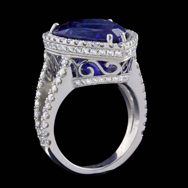 For Sale on 1stdibs - Platinum Cocktail Ring Features a Stunning Natural Vivid Blue 12.67 Carat Pear Shape Tanzanite set in a Halo of Round Brilliant Cut Diamonds. Additional Luxury Tanzanite Diamond Ring For Formal Occasions, Classic Tanzanite Ring For Formal Occasions, Formal Sapphire Ring With Brilliant And Cushion Cut, Formal Sapphire Ring With Cushion Brilliant Cut, Luxury Blue Topaz Ring In Platinum, Luxury Tanzanite Diamond Ring With Brilliant Cut, Luxury Tanzanite Diamond Ring With Halo Setting, Luxury Tanzanite Rings For Formal Occasions, Luxury Formal Tanzanite Ring