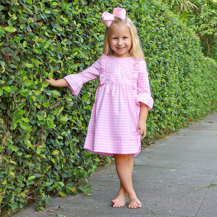 Your little one will fall in love with our Pink Check Olivia Dress for all their pumpkin patch adventures! This adorable Olivia-style dress, in charming pink gingham check, is perfect for endless pumpkin picking and fall festivities. Add a monogram to make this outfit uniquely theirs and even more fun! Coordinates perfectly with our Pumpkin Hayride collection. Casual Pink Plaid Dress With Ruffles, Preppy Pink Dress For Spring, Preppy Pink Spring Dress, Cute Long Sleeve Gingham Dress, Cute Pink Plaid Dress With Ruffles, Fall Gingham Plaid Dress With Ruffles, Fitted Pink Plaid Dress For Spring, Playful Pink Fall Dress, Casual Pink Plaid Cotton Dress