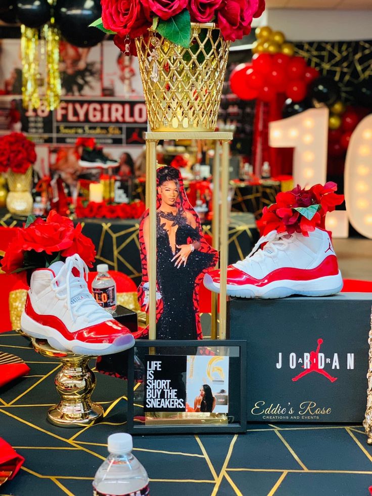 a display in a store with red roses and shoes on the table next to it