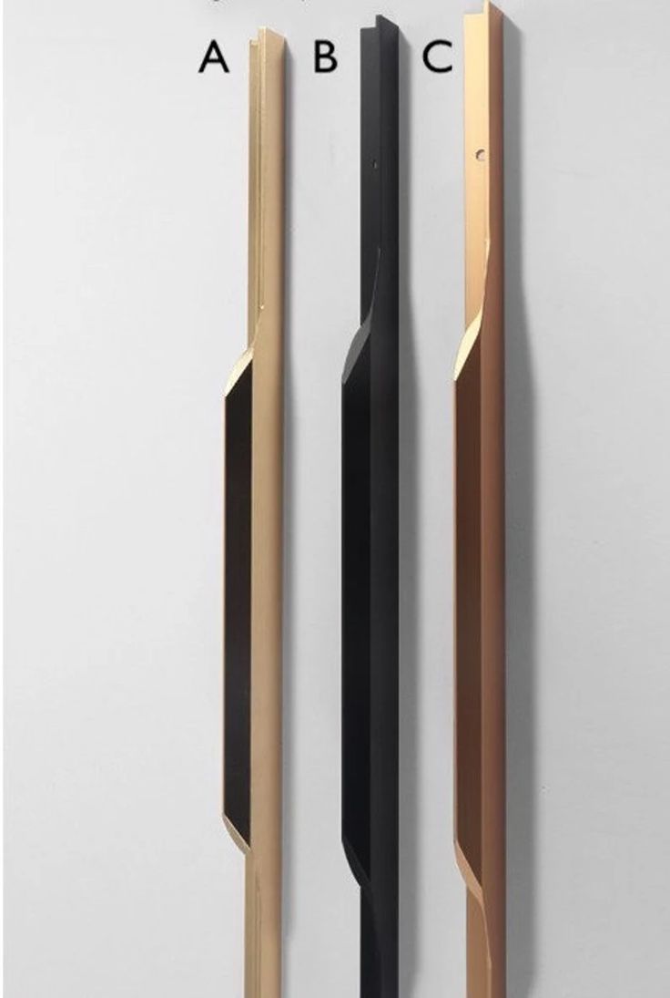 three different types of door handles on a white wall with black and gold trims