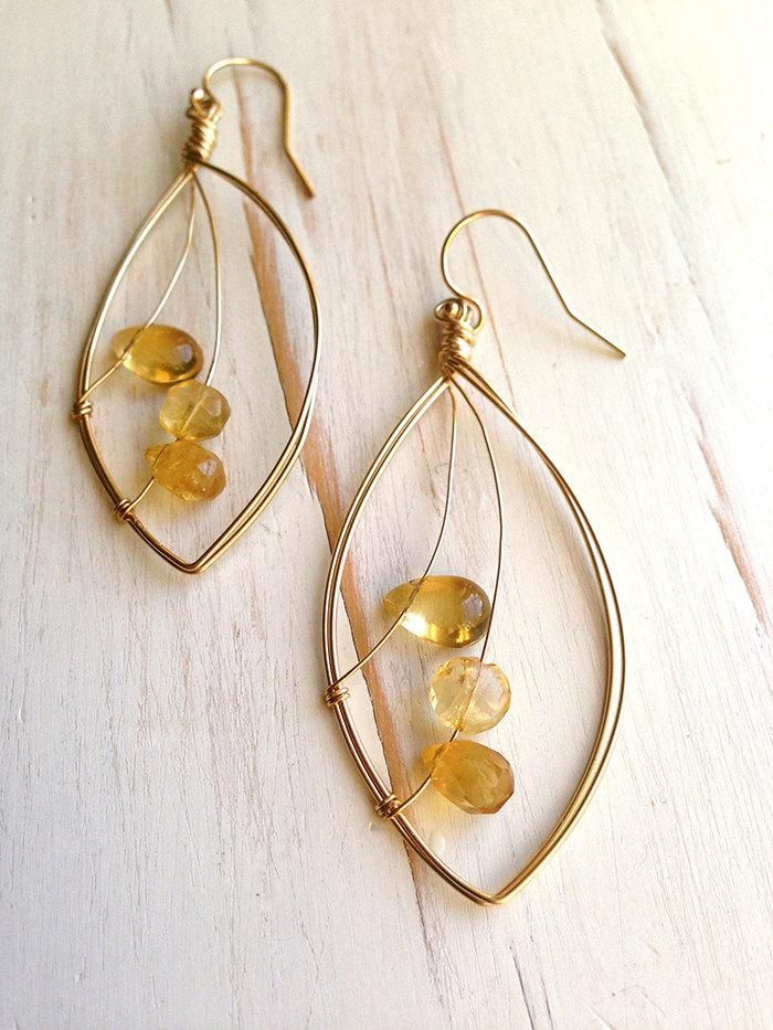 A mix of tiny citrine stones float across a delicate leaf of 14k gold filled wire.Size is a little over 2 inches.MATERIAL:GOLD-FILLED - 14k Gold filled is considerably durable and considered a lifetime piece of jewelry. This is NOT gold plated or gold dipped vermeil jewelry which can chip off over time with wear. Gold filled metal is essentially a 14k gold tube filled with an inner core metal such as brass and has been mechanically bonded with high very hot heat. It will never chip or flake off Cheap Wire Wrapped Small Hoop Earrings, Wire Jewelry Earrings Set, Dainty Earrings With Ear Wire, Cheap Small Wire Wrapped Hoop Earrings, Simple Wire Earrings Rustica Jewelry, Cheap Dainty Earrings With Ear Wire, Flat Jewelry Wire, Bead Wire Wrapped Earrings, Beads And Wire Earrings