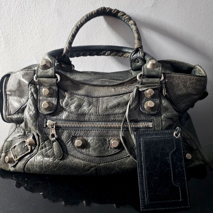 This Is A Vintage Grey Gsh Balenciaga City Part-Time Bag! It Has Giant 21 Silver Hardware And Is Made Of Grey Leather Which Is Beautifully Distressed. This Style Comes With A Removable Shoulder Strap (Not Pictured) And Matching Mirror. Measures 17" Across, 9.5" Tall And 6" Deep. Hard To Find Color And Style! Bundle And Save Or Make Me An Offer!Can Ship Same Day Mon-Fri If Payment Is Received Before 9:00pm Est Or Saturdays Before 1:00pm Est! Balenciaga Giant City Bag, Vintage Balenciaga, Style Bundle, Grey Bag, Find Color, Balenciaga Bag, Part Time, Balenciaga City Bag, Grey Leather