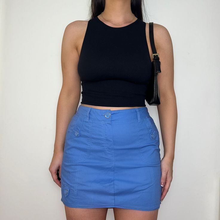 "Reworked skirt made from PreLoved cargo trousers, dusty blue colour with front and back pockets with button closure.  Colour: Light Blue Style: Cargo Skirt Size: Best fits UK 12 (US 8)* Measurements: Waistband - 15\" Length - 15\"   Model: Size Top UK 8/10 (US 4/6) Bottoms UK 10/12 (US 6/8) Height 5ft5\"   *Please contact us if you would like this item to be altered to fit a smaller size." Y2k High Waist Cargo Skirt With Pockets, Blue Y2k Skort With Pockets, Y2k Style Fitted Cargo Skirt With Pockets, Y2k Blue Skirt With Pockets, Fitted Utility Skirt, Blue Cotton Y2k Style Skort, Casual Cargo Pocket Skirt, Blue Cotton Y2k Skort, Y2k Style Blue Cotton Skort