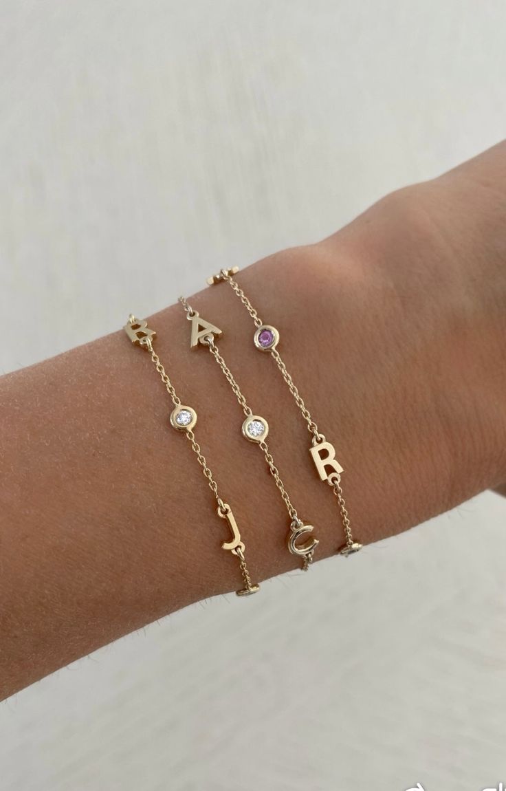 This beautiful bracelet features up to six 14K gold letters of your choice. Choose from several options for the accent stones! EXAMPLE SHOWN: Letter #1: R Stone #1: diamond Letter #2: J Stone #2: diamond Letter #3: J Available in 14K Yellow Gold, 14K White Gold or 14K Rose Gold Measures 6" + 1" extender Letter measures approx. 5mm Each letters measurement will vary slightly based on the letter FINAL SALE Friendship Bracelets With Initials, Letter Bracelets Gold, J Bracelet Letter, Cheap Birthday Charm Bracelet With Letter Beads, Diamond Letter Bracelet, Anniversary Yellow Gold Name Bracelet With Diamond Accents, Personalized Yellow Gold Diamond Bracelets, Elegant Diamond Bracelets With Initials, Anniversary Yellow Gold Diamond Name Bracelet