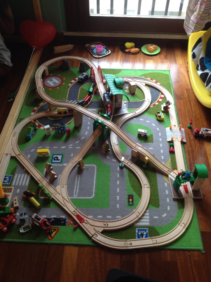 a child's toy train set is on the floor