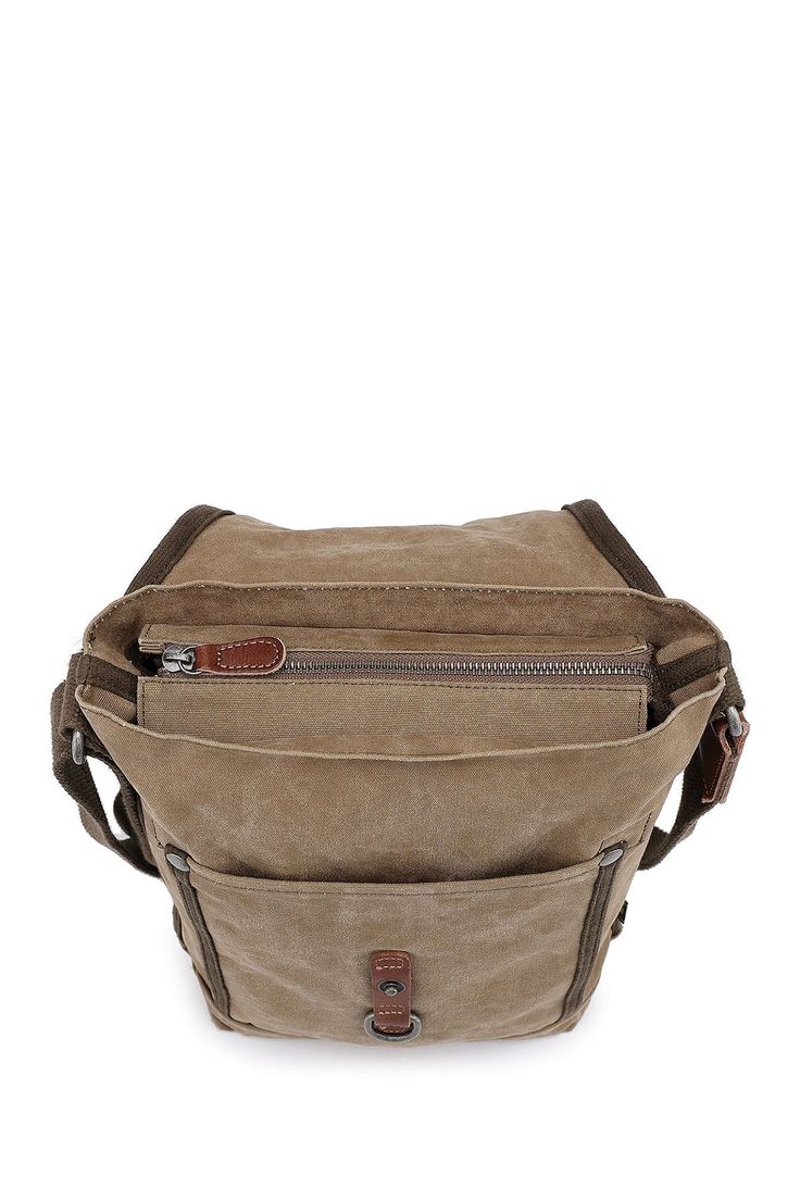 Featuring our military-Inspired Forest Crossbody Bag, designed and handcrafted from high-quality canvas, which allows you to securely carry all of your essentials at ease. . Foldover flap with interior zip closure. Adjustable crossbody strap. Interior features include 4 slip pockets and 1 zip pocket. Handcrafted. Approx. 10" x 8" x 3". Approx. 25" strap drop. Imported Exterior: cotton canvas, leather, recycled hardware, vegetable base dyes Lining: cotton Casual Crossbody Satchel For Everyday Carry, Khaki Duck Canvas Bag With Canvas Lining, Functional Khaki Canvas Bag For Everyday Use, Functional Khaki Canvas Bag, Outdoor Canvas Shoulder Bag With Cell Phone Pocket, Khaki Canvas Bag With Zipper Pocket For Everyday Use, Functional Khaki Bags With Canvas Lining, Canvas Shoulder Bag With Cell Phone Pocket For Travel, Functional Khaki Bag With Canvas Lining