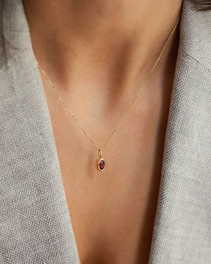 Description Elevate your jewelry collection with our Oval Ruby Pendant Necklace, a timeless piece signed for the woman who appreciates minimalist elegance. The necklace features a captivating oval-cut ruby, securely bezel set in 14k solid gold. With its clean lines and impeccable craftsmanship, this necklace effortlessly enhances any look, from formal to casual. Details * 4x6mm oval cut ruby * 14K solid gold * Chain length: 40cm + 3cm (16" + 1.18") * Ready to ship in 14K yellow gold Processing t Minimalist Oval Gemstone Jewelry, Timeless Oval Everyday Necklaces, Elegant 14k Gold Birthstone Necklace With Oval Pendant, Refined Oval Necklace For Gifts, Timeless Oval Necklace For Everyday, Minimalist Oval Jewelry With Bezel Setting, Yellow Gold Oval Minimalist Necklaces, Minimalist Oval Yellow Gold Necklaces, Minimalist Oval Cabochon Jewelry