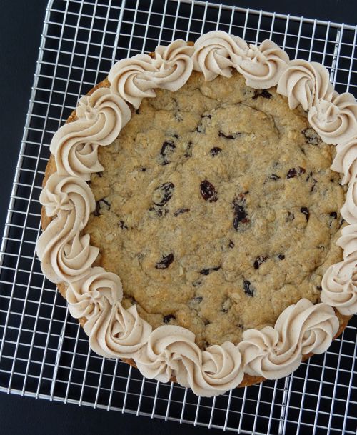 a cookie cake sitting on top of a cooling rack