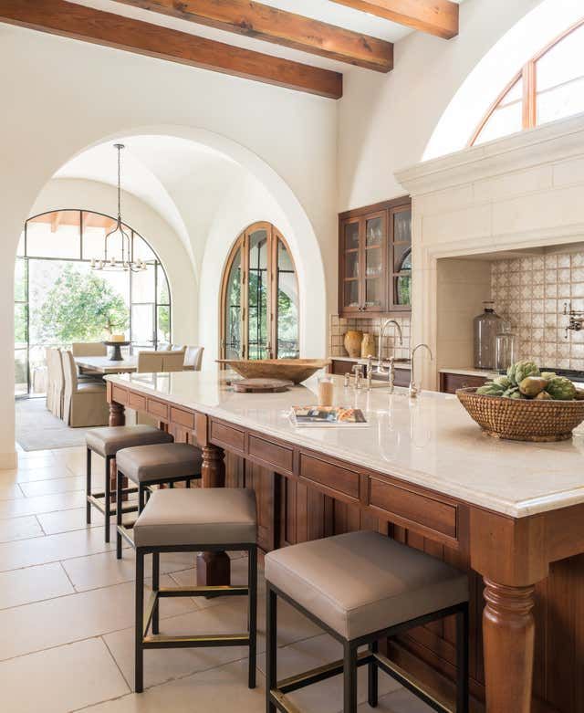 a large kitchen with an island and seating area