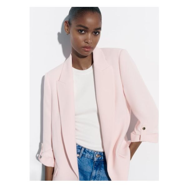 Open front blazer with lapel collar and shoulder pads. Below-the-elbow length cuffed sleeves with gold buttoned tabs. Front flap pockets. Chic Spring Blazer With Button-up Design, Chic Spring Blazer With Double Button Closure, Chic Collared Blazer, Single Breasted Blazer For Spring Workwear, Single-breasted Blazer For Spring Workwear, Single-breasted Spring Workwear Blazer, Spring Single-breasted Blazer For Workwear, Spring Single Breasted Blazer For Work, Trendy Blazer With Double Button And Notch Lapel