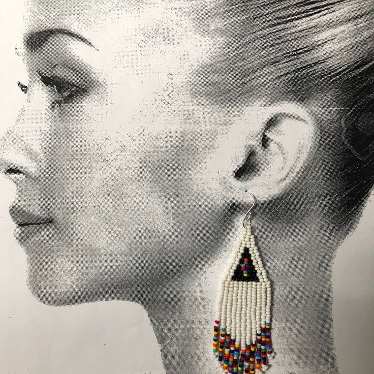 Handmade beaded white and multicolored seed bead earrings. Stunning handmade beaded earrings made with white and super bright multicolored 11/0 seed beads. The earrings have long flowing multicolored fringe. The french hook earwires and findings are sterling silver. These gorgeous Cheyenne style earrings are super long and brush your shoulders ever so slightly. Great for daywear and stunningly beautiful for the night out. Earrings measure approximately 4.5 inches including ear wires. Stylishly s White Beaded Fringe Dangle Earrings, White Beaded Fringe Dangle Jewelry, Traditional Multicolor Beaded Earrings With Beaded Chain, White Beaded Fringe Earrings For Festival, Traditional Multicolor Beaded Chain Earrings, White Teardrop Beaded Earrings, Traditional White Beaded Earrings For Festivals, Bohemian White Beaded Fringe Earrings, Traditional White Beaded Fringe Jewelry