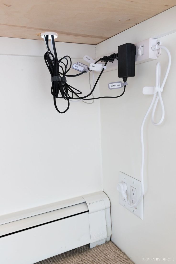 an electrical outlet is plugged into the wall in this small room with white walls