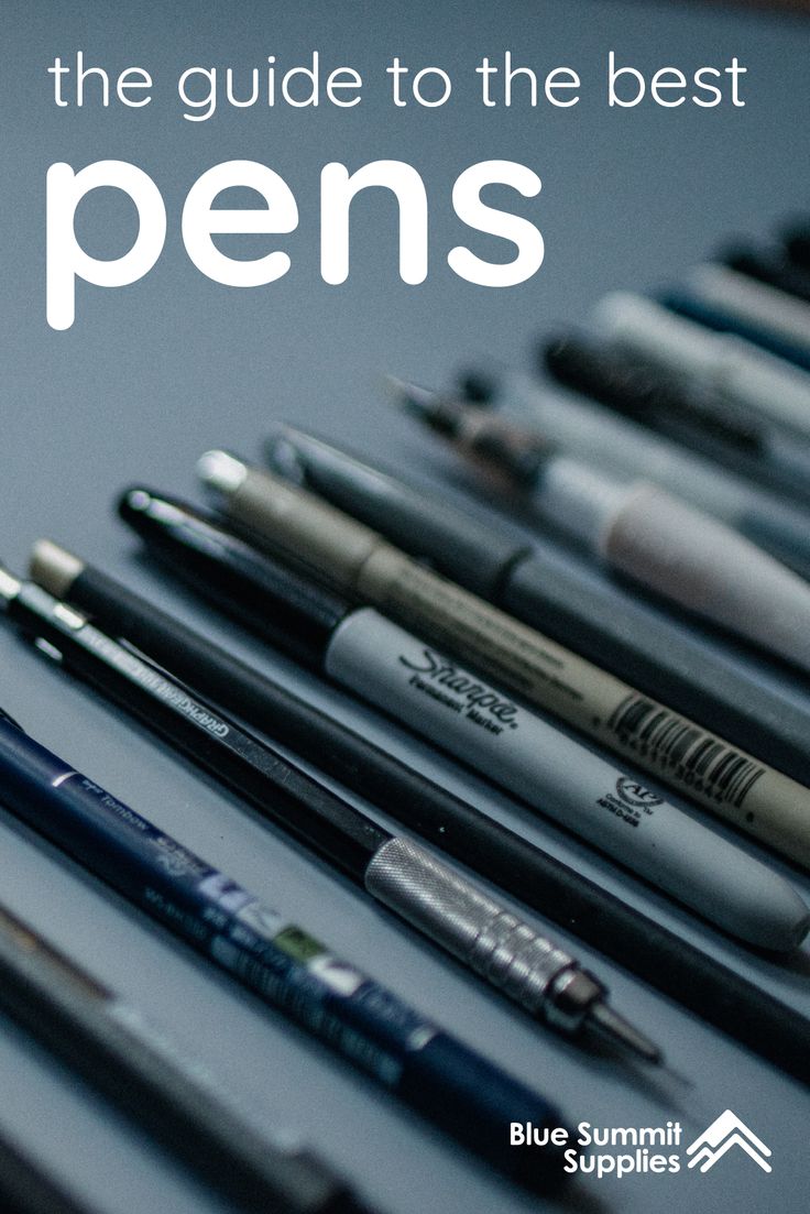 several pens lined up next to each other on top of a table with one pen in the middle