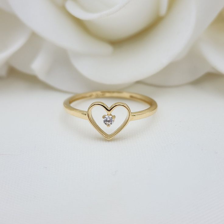 Our Adorable solid Gold Heart Solitaire CZ ring is crafted in Solid 14k Gold which makes it perfect to wear everyday and in every occasion.this ring is simple yet perfect. Unique, elegant and everlasting. 14k Gold will not tarnish or rust. Materials: 14k Gold, CZ Diamonds Stone size: 2mm Heart size: 8x7mm Band width: 1.5mm Weight: 1.3 grams 14k stamped  Brand new Follow us in our social media for more solid 14k Gold Jewelry. Please. Do not hesitate to contact me i will be happy to answer all you 14k Gold Heart-shaped Solitaire Ring, Dainty Heart-shaped Promise Birthstone Ring, Dainty Heart Shaped Birthstone Promise Ring, Dainty Heart Birthstone Promise Ring, 14k Gold Heart Ring With Single Diamond For Promise, 14k Gold Solitaire Heart Ring For Valentine's Day, Delicate 14k Gold Heart Ring For Promise, Delicate 14k Gold Heart Promise Ring, Elegant Heart Cut Rings For Everyday