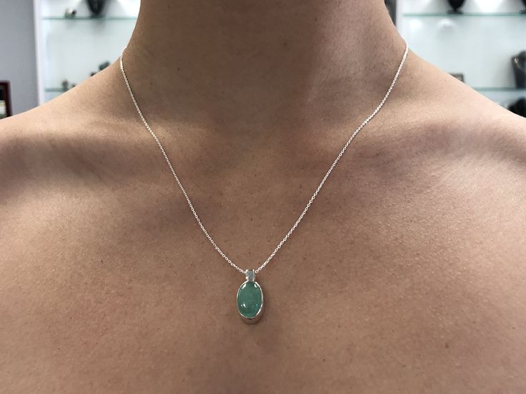 Featured here is a stunning, cabochon oval Colombian emerald necklace in fine .925 sterling silver. Displayed is a light-green emerald bezel set in an elongated silver setting. The earth mined, green Colombian emerald has a light green color with good clarity. An 18 inch chain is included with the emerald pendant. This is an excellent gift for a May baby or for someone who simply loves emeralds. Total Carat Weight: 5.0cts Setting Style: Bezel Setting Material: .925 Sterling Silver Main Stone: Co Luxury Teardrop Cabochon Jewelry, Silver Oval Pendant With Emerald, Silver Teardrop Pendant Emerald Necklace For Formal Occasions, Elegant Oval Pendant Necklace With Natural Stones, Oval Fine Jewelry Gemstones For Jewelry Making, Elegant Cabochon Teardrop Pendant Necklace, Oval Cabochon White Gold Jewelry, Elegant Teardrop Pendant Cabochon Necklace, Polished Finish Oval Cabochon Necklace