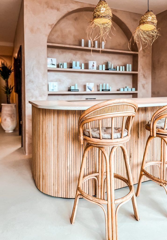 two wicker bar stools in front of a counter