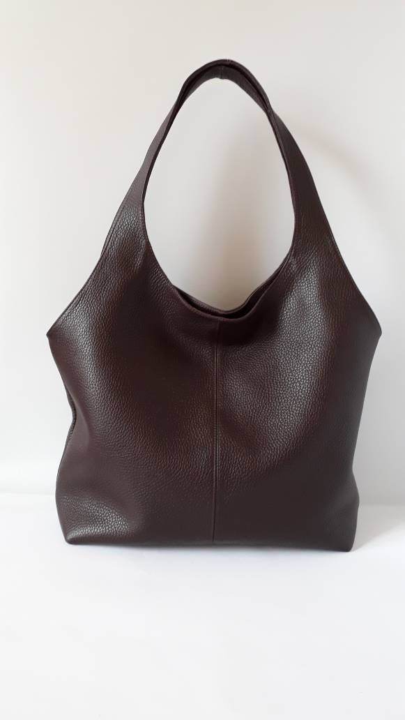 "This hand bag is crafted from textured soft leather in brown . It's the ideal size for taking you from desk to dinner, and can be worn over the shoulder for hands-free. - Two shoulder straps. - Pleated top with magnetic fastening. - You can choose from 8 leather colors. - Cotton lining with zip close compartment for securing your necessities, you can choose from 7 different linings. Free delivery is economic delivery. We use Latvian post and delivery can take 1-3 weeks in the EU, 3-4 weeks ever Brown Textured Leather Hobo Bag With Double Handles, Brown Textured Leather Hobo Tote Bag, Brown Textured Faux Leather Shoulder Bag, Brown Hobo Bag With Soft Leather And Double Handle, Brown Soft Leather Hobo Bag With Double Handle, Elegant Brown Hobo Bag, Leather Hobo Bag With Rolled Handles, Brown Textured Leather Hobo Shoulder Bag, Everyday Brown Faux Leather Hobo Bag