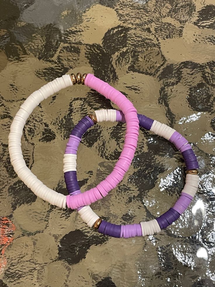 💜Is your favorite color purple? Then this bracelet is for you!   💜Clay bead or also know as Heishi beads- bracelet is 7 in. long.  💜First bracelet💜      Dark purple, white and lavender clay beads with gold spacers.  💜Second bracelet💜       White and lavender clay beads with golden spacers.  💜 Made as a great gift idea!! Bohemian Purple Beaded Bracelets With Letter Beads, Purple Friendship Bracelets With Colorful Beads, Trendy Purple Jewelry With Spacer Beads, Bohemian Purple Beaded Bracelets With Large Beads, Purple Letter Beads For Jewelry Making, Purple Bracelet Jewelry For Beach, Purple Bracelet Jewelry For The Beach, Purple Heishi Bead Jewelry With Colorful Beads, Purple Beaded Bangle Bracelets For Friendship