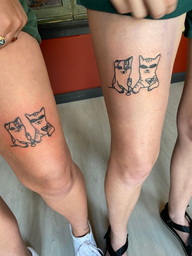 two women with matching tattoos on their legs