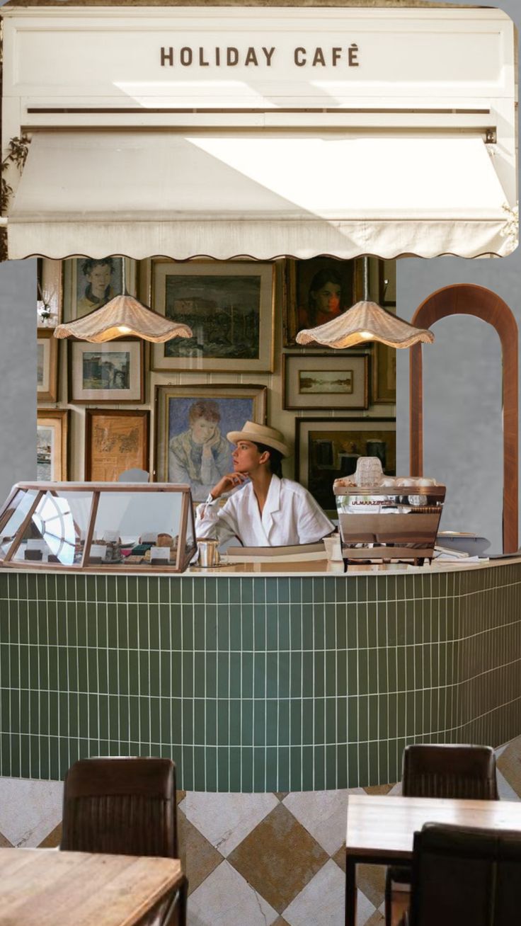 a man sitting at a restaurant counter with an umbrella over his head in front of him