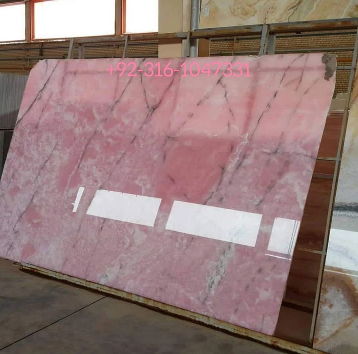 a large pink marble slab in a warehouse