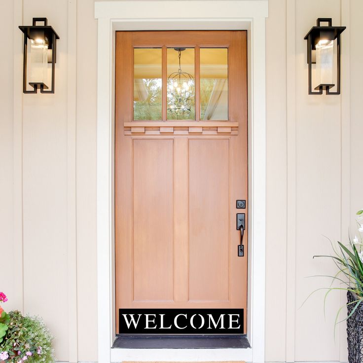 a welcome sign on the front door of a house