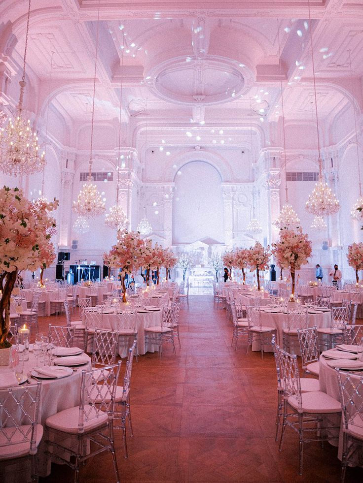 an indoor wedding venue with tables and chairs set up for a formal dinner or reception