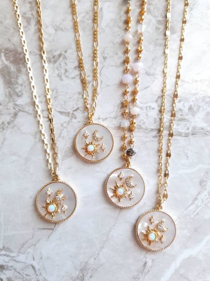 "Dainty white mother of pearl sun & moon necklace with opal & CZ -------------------- Detail *Mother of pearl circle charm measures 15 mm *16K gold plated 1.2mm box chain *16K gold plated 1.6 x 0.7mm Figaro Chain *16K gold plated 4.3 x 1.8 mm Hammered Lace Chain *Glass beaded chain -------------------- Necklace Length *This necklace is available in 3 sizes. 14\" - 16\" (14\" + adjustable 2 - inch extender) 16\" - 18\" (16\" + adjustable 2 - inch extender) 18\" - 20\" (18\" + adjustable 2 - inch Sun Moon Necklace, Necklace Sun, Sun And Moon Necklace, Mother Of Pearl Pendant, Necklace Opal, Mother Of Pearl Jewelry, Celestial Necklace, Mother Of Pearl Necklace, Figaro Chain