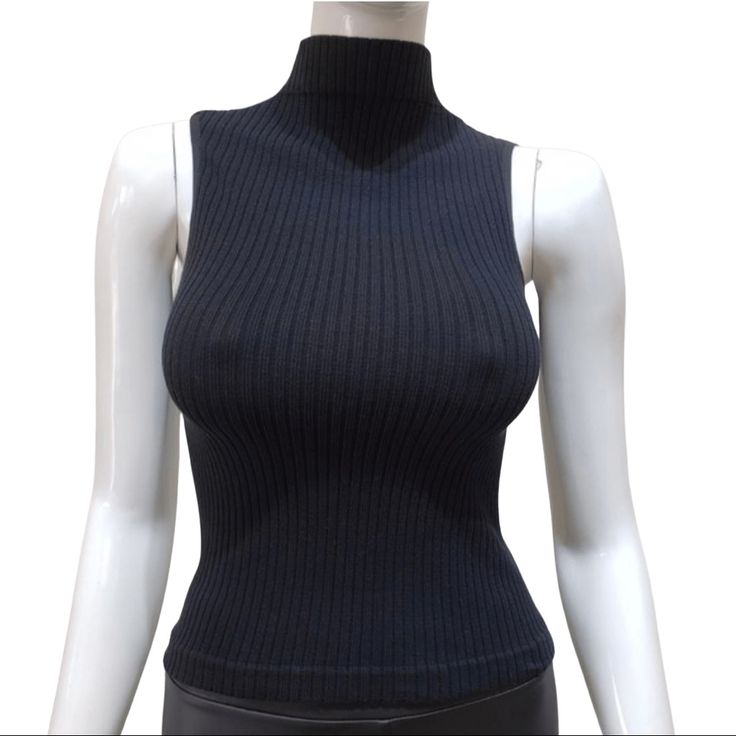 Black Rib-Knit Sleeveless Top With Mock Neck. Fabric55% Cotton 40% Nylon 5% Spandex One Size Turtle Neck Sleeveless Top Outfit, Black Stretch High Neck Tank Top, Stretch Ribbed Sleeveless Vest, Black Stretch Sleeveless Sweater Vest, High Neck Stretch Knit Tank Top, Black Fitted Tank Top For Winter, Fitted Black Tank Top For Winter, Stretch Knit High Neck Tank Top, Stretch Ribbed Turtleneck Tank Top