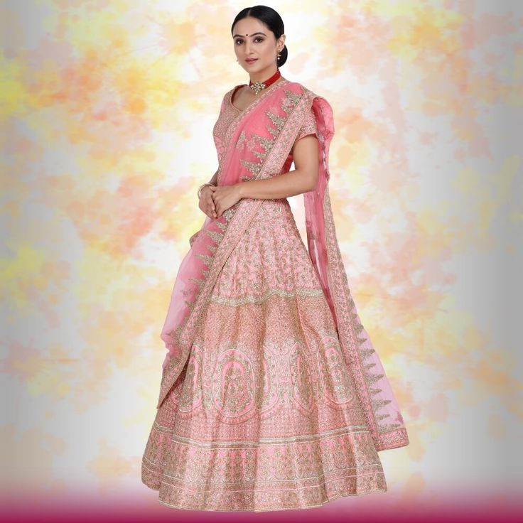 Looking for an elegant and traditional pink bridal lehenga for your wedding day? Look no further than this beautiful piece, made with luxurious silk and finished with gorgeous temple border embroidery on the dupatta and beautiful henna design embroidery on the lehenga. The entire piece is adorned with diamond work, making it truly special and perfect for your big day. You'll feel like a royal princess in this lovely lehenga! Pink Chandbali Choli With Intricate Embroidery, Pink Kundan Dupatta With Intricate Embroidery, Pink Dola Silk Chandbali Lehenga, Pink Kundan Bollywood Saree, Bollywood Style Pink Kundan Saree, Pink Art Silk Choli With Dori Work, Bollywood Pink Kundan Saree, Pink Kundan Saree For Diwali, Bollywood Style Pink Traditional Wear With Kundan