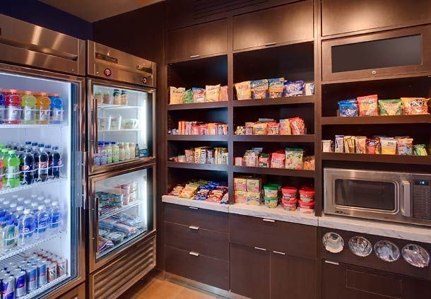 the refrigerator is stocked with drinks and snacks