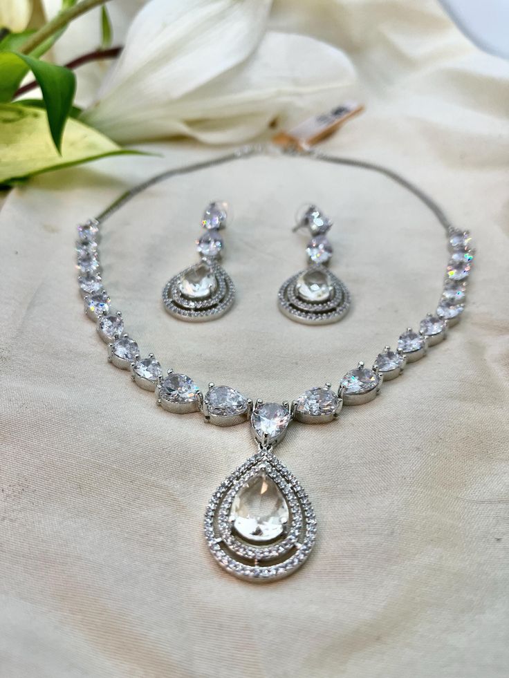 Embrace the epitome of elegance with our Royal Necklace Set with Drop Earrings. This magnificent collection features a regal necklace paired with exquisite drop earrings, each piece meticulously crafted to perfection. Adorned with dazzling gemstones, this set exudes sophistication and grandeur, making it perfect for any special occasion. Experience the luxurious beauty and impeccable craftsmanship of our Royal Cubic Zirconia Necklace Set with Drop Earrings. Regal Necklace, Royal Necklace, Zirconia Necklace, Cubic Zirconia Necklace, Wedding Jewellery, Wedding Jewelry Sets, Necklace Set, Jewelry Sets, Aurora