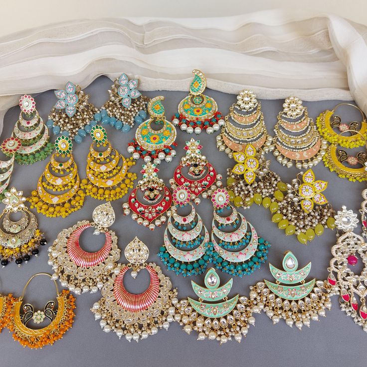 A pair of golden-toned Hand Painted Traditional Meenakari Earring for Saree.  Size & Other Details Material : Brass, Pearl, Meena work Shape : Flower Shaped Attire : Lehenga Choli, Salwar Suit, Kurti, Saree, Flared Dress FYI: Assorted designs will come depending on the stock available. 5 color left Shop more: https://www.etsy.com/shop/FashionCrabIndia/ Style Tip ---------------------------- Elevate your traditional outfits with our unique collection. Perfect for festivals. Care Tips ---------------------------- Avoid perfume and moisture. Store in a dry place, Ziplock bag, or airtight box. Clean with a dry cloth. Remember, jewelry is the last thing to wear and the first to remove. For international customers ---------------------------- Import duties and taxes may apply, paid by customers. Multicolor Temple Jewelry Chandbalis With Tilla, Multicolor Chandbalis With Tilla In Temple Jewelry Style, Traditional Multicolor Round Hoop Earrings, Traditional Multicolor Hoop Earrings, Festive Bridal Earrings With Meenakari, Traditional Multicolor Chandbali Hoop Earrings, Traditional Kundan Jhumkas With Motifs, Multicolor Chandbali Jhumkas For Diwali, Diwali Multicolor Chandbali Jhumkas