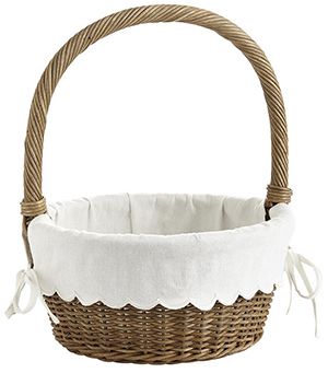 a wicker basket with white linen lining