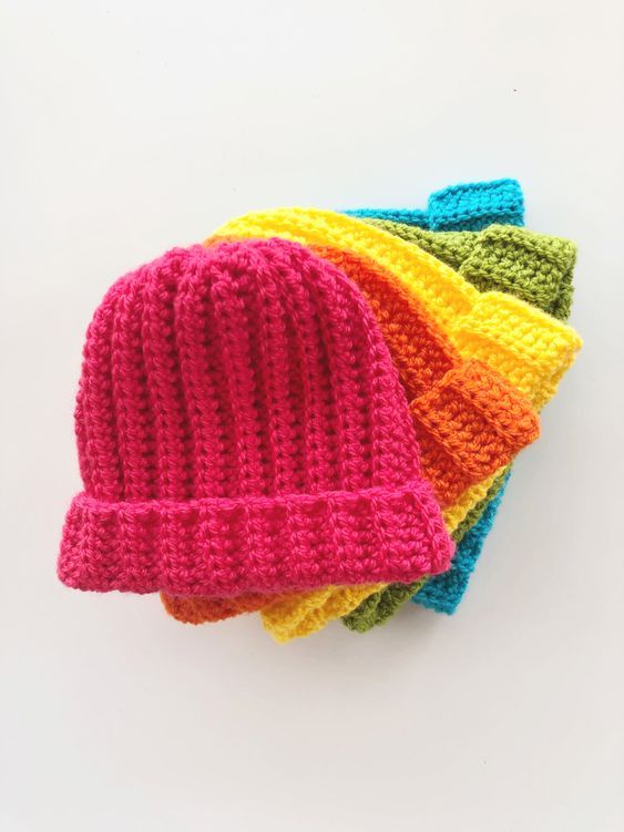 three crocheted hats are sitting on top of each other