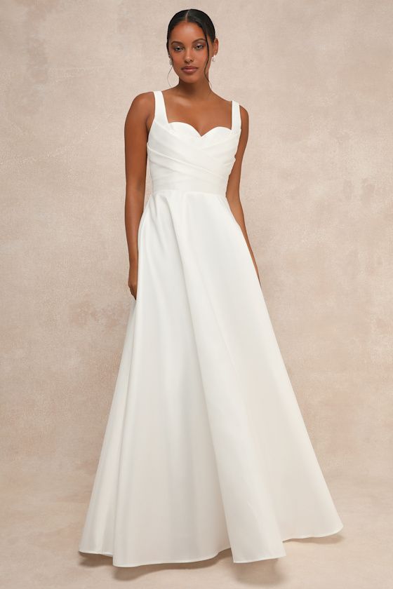 With a timeless silhouette and an undeniably romantic personality, the Lulus Modern Affection White Taffeta Pleated Sleeveless Maxi Dress is the perfect dress for your big day! Sleek and structured woven taffeta shapes wide straps that support a bodice with a classic sweetheart neckline, lightly padded cups, and a crisscrossing pleated design that lends a contemporary touch to this gorgeous dress. Fitted waist tops a full, ballgown-style skirt that has a layer of hidden tulle for volume. Low bac A-line Wedding Dress With Fitted Bodice, Classic Wedding Dress With Ruched Bodice, Classic Sleeveless Dress With Ruched Bodice, Sleeveless Wedding Dress With Corset Back, Sleeveless Wedding Dress For Debutante Ball, Wedding Dress With Pleated And Fitted Bodice, Sweetheart Neckline, Sleeveless Dress With Pleated Bodice For Debutante Ball, Sleeveless Bridesmaid Wedding Dress With Boned Bodice, Sleeveless Dress With Ruched Bodice For Debutante Ball