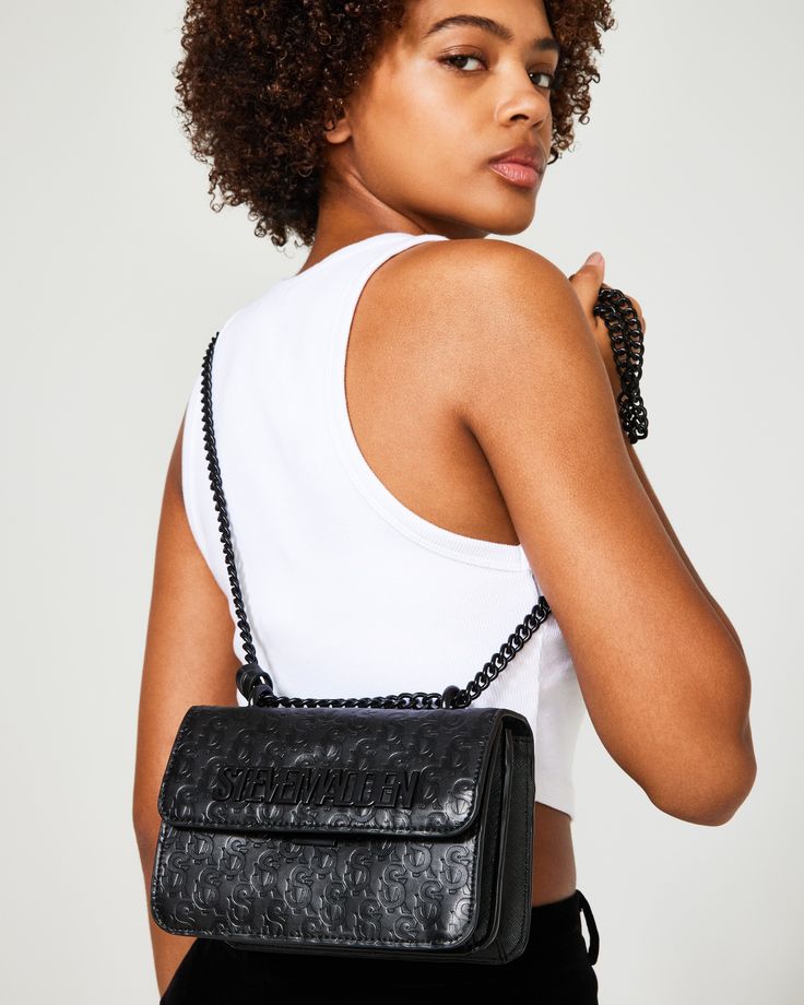 POLISHED + EFFICIENT + SHARP The structured COAL Bag crossbody bag is designed with expandable side gussets so you'll have plenty of room for all your essentials. Structured crossbody bag Flap closure at front All-over embossed logo pattern Removable logo tag Chain strap for crossbody and over-the-shoulder wear Crossbody strap drop: 24 inches 5.5in H x 8in W x 3.25in D Synthetic materials Imported Branded Shoes For Men, Wardrobe Upgrade, Steve Madden Store, Crossbody Bag Women, Synthetic Materials, Logo Tag, Logo Pattern, Summer Events, Women's Handbags