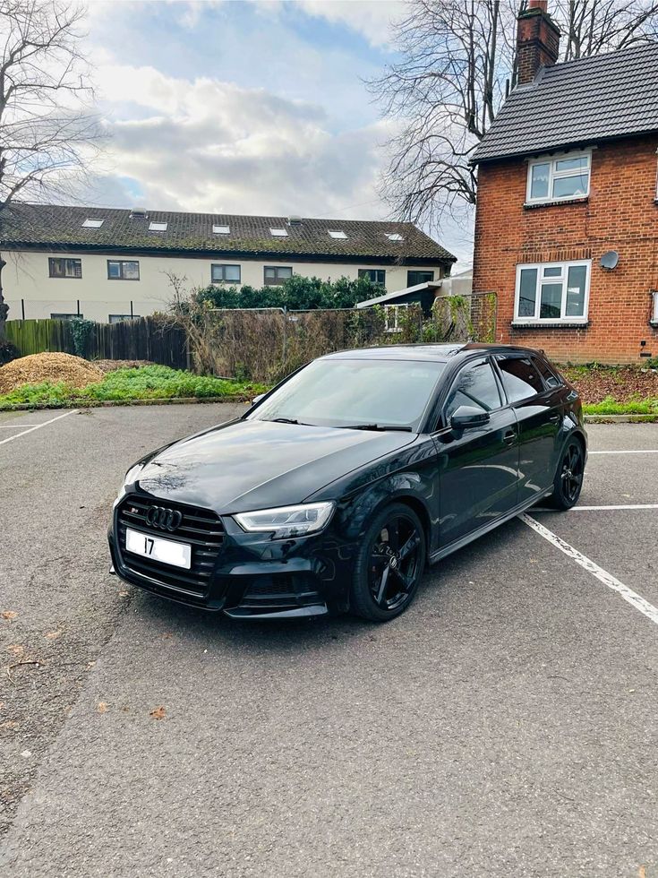 a black car parked in a parking lot