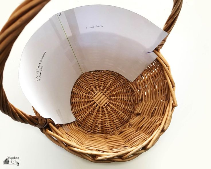 a wicker basket sitting on top of a white table