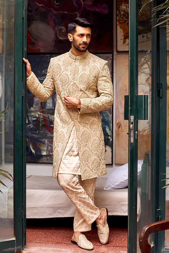 Buy Hand-Embroidered Men's Groom Sherwani in Jamawar Fabric emblazoned with lavish designs and fine details. This Pakistani Groom Dress is available Online Beige Sherwani Groom, Pakistani Groom Dress, Men Sherwani, Indian Groom Dress, Groom Sherwani, Red Lehenga Choli, Embroidered Sherwani, Pakistani Bridal Dress, Groom Dress Men