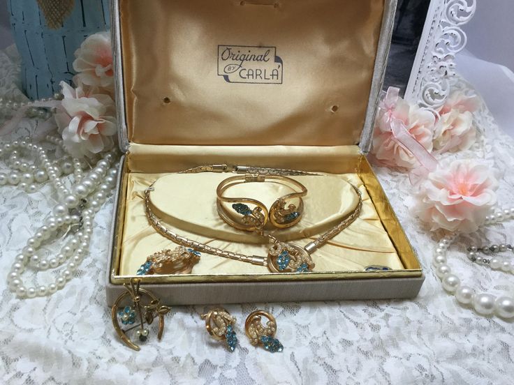 Beautiful complete vintage jewelry set. All gems are intack. Set includes necklace, spring action cuff bracelet, screw earrings, and two brooches. Box is marked Original by Carla. Vintage Gold Jewelry Sets For Gift, Vintage Jewelry Sets With Matching Earrings For Formal Events, Vintage Jewelry Sets With Matching Earrings For Formal Occasions, Vintage Hallmarked Jewelry For Vintage Events, Vintage Jewelry Sets For Wedding, Vintage Wedding Jewelry Sets With Jewels, Vintage Gold Jewelry Sets For Anniversary, Retro Formal Jewelry With Matching Earrings, Vintage Jewelry Sets For Formal Occasions