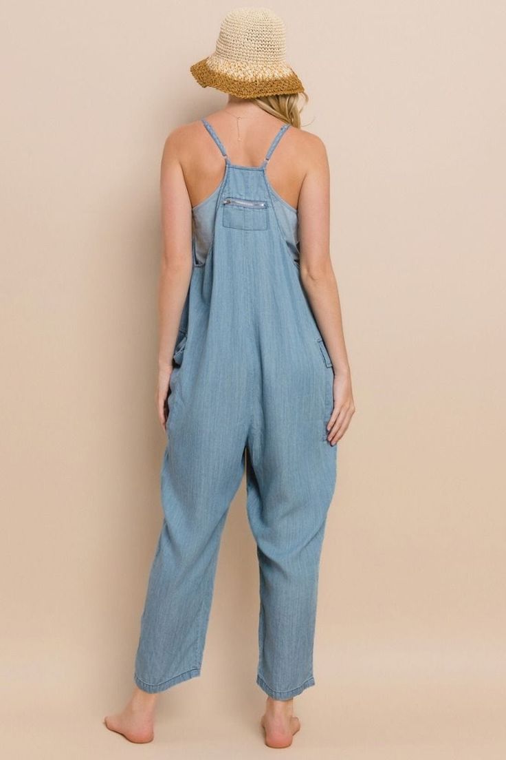 Rock a carefree, edgy look in our Acid Washed Chambray Jumpsuit! Oversized for effortless style, this jumpsuit features front and side pockets for added convenience. Perfect for a day out, you'll be sure to turn heads and make a statement with this unique piece. Details:- Spaghetti Straps- Back Zip Pocket- 2 Side-Pockets- V-Neckline- Light Denim Color Fabric Content:- 100% Tencel Trendy Cotton Beach Overalls, Casual Solid Color Overalls Romper, Trendy Cotton Overalls For The Beach, Casual Solid Bib Front Jumpsuits And Rompers, Casual Solid Bib Front Jumpsuit/romper, Casual Solid Color Jumpsuit With Bib Front, Cotton Overalls With Pockets For Vacation, Cotton Overalls With Adjustable Straps For Beach, Summer Overalls With Pockets For Loungewear