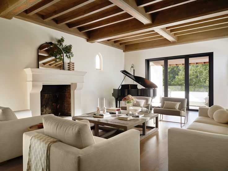 a living room filled with furniture and a piano in the middle of an open floor plan