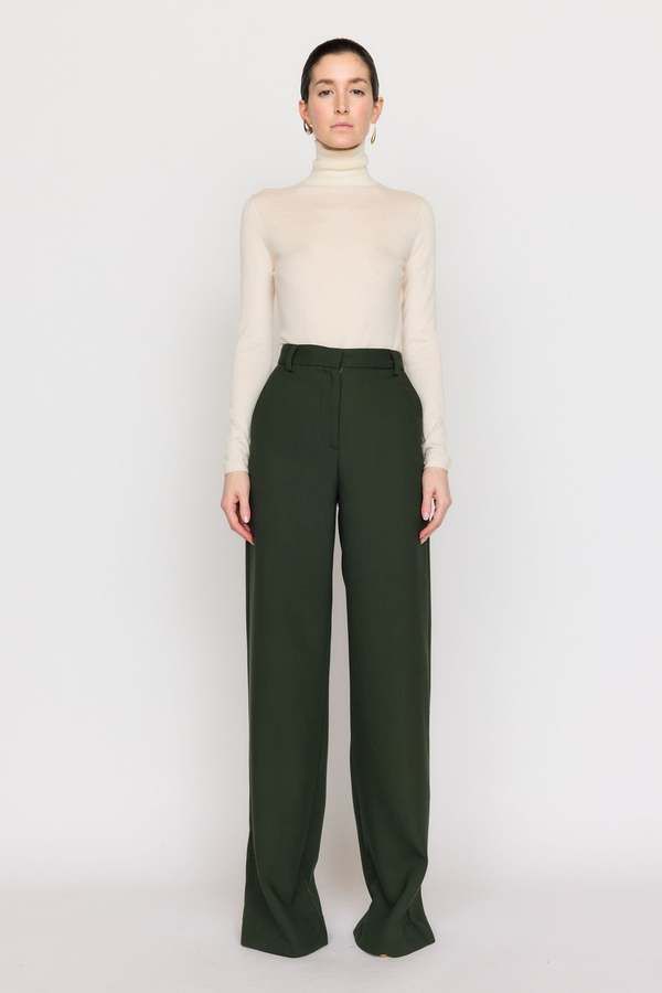 A timeless bootcut silhouette our cora pant is made from our italian twill suiting that’s blended with wool. this high-waist style features a front fly with zipper and a wide cuff at the hem. this classic forest hue invites neutrality and versatility to your wardrobe.    composition: wool twill  care: dry clean only  imported. Elegant High Waist Wool Dress Pants, Elegant High-waist Wool Dress Pants, Tailored Wide-leg Dress Pants For Fall, Spring Wool Dress Pants For Workwear, Spring Wool Wide Leg Workwear Pants, Wool Wide Leg Pants For Workwear In Spring, Spring Wool Wide Leg Pants For Workwear, Tailored High Waist Wool Wide Leg Pants, Tailored Wool High Waist Wide Leg Pants