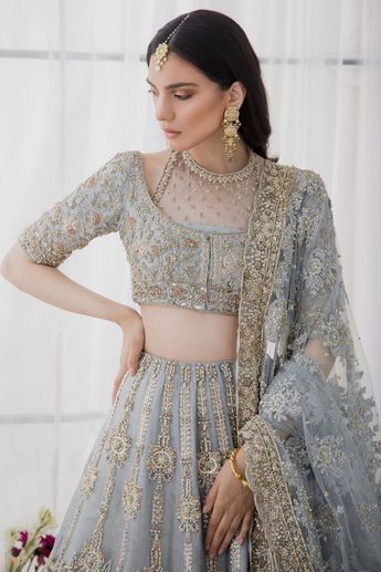 Indian Ice Blue Lehenga Choli for Bridal Wear is an elegant masterpiece to wear on your big day. This breathtaking Indian Bridal Dress wins everyone's hearts at the very first glance. Hand-worked embellishments and royal designs make this breathtaking bridal dress your foremost priority of the day. Choli: Beautiful blouse choli in ice blue color comes in luxurious net fabric which is gracefully embellished with zardosi, pearls, and crystals. magnificent lining on the choli enhancing the overall Elegant Lehenga With Intricate Embroidery For Ceremony, Elegant Ceremony Lehenga With Intricate Embroidery, Elegant Lehenga With Dupatta For Ceremony, Elegant Choli For Ceremony With Traditional Drape, Elegant Ceremony Choli With Traditional Drape, Elegant Choli With Intricate Embroidery For Ceremonies, Elegant Saree Sets For Ceremony, Formal Blue Embroidered Lehenga, Anarkali Saree With Intricate Embroidery For Ceremony